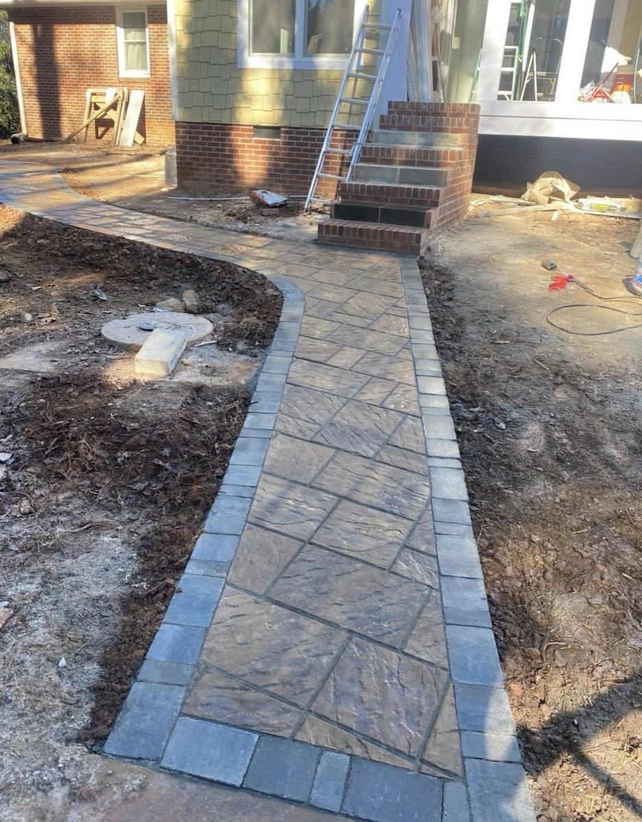 Paver walkway with charcoal border leading to brick front steps